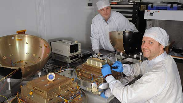 Technicians at the US Naval Research Lab prepare the SpinSat for its twoyear mission