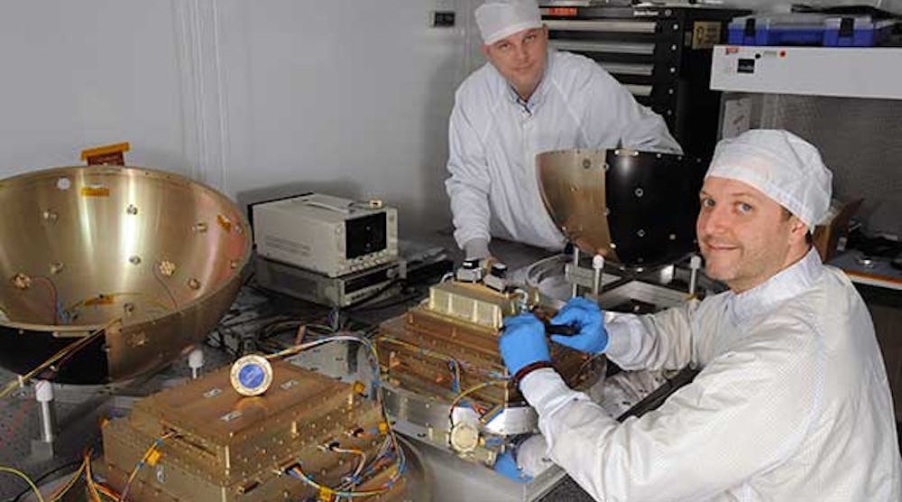 Technicians at the U.S. Naval Research Lab prepare the SpinSat for its two-year mission.