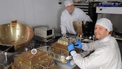 Technicians at the US Naval Research Lab prepare the SpinSat for its twoyear mission Technicians at the US Naval Research Lab prepare the SpinSat for its twoyear mission
