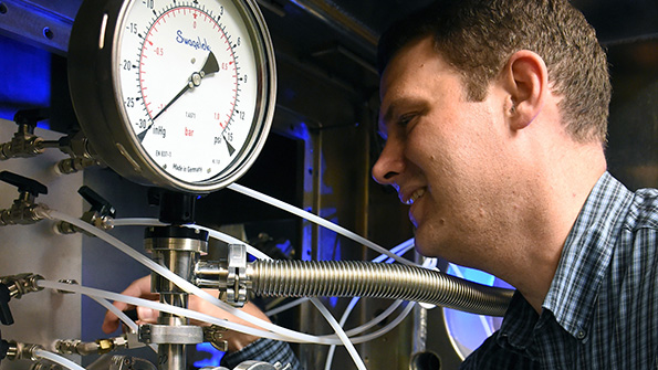 A chemist at the NRL checks the KrF laser being used to clean up emissions from coalburning power plants by destroying NOx in the flue gas
