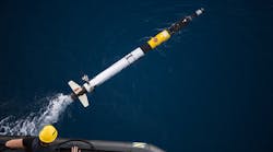 A team member launches an Iver autonomous underwater vehicle AUV On the rear is the transceiver fins and thruster A team member launches an Iver autonomous underwater vehicle AUV On the rear is the transceiver fins and thruster