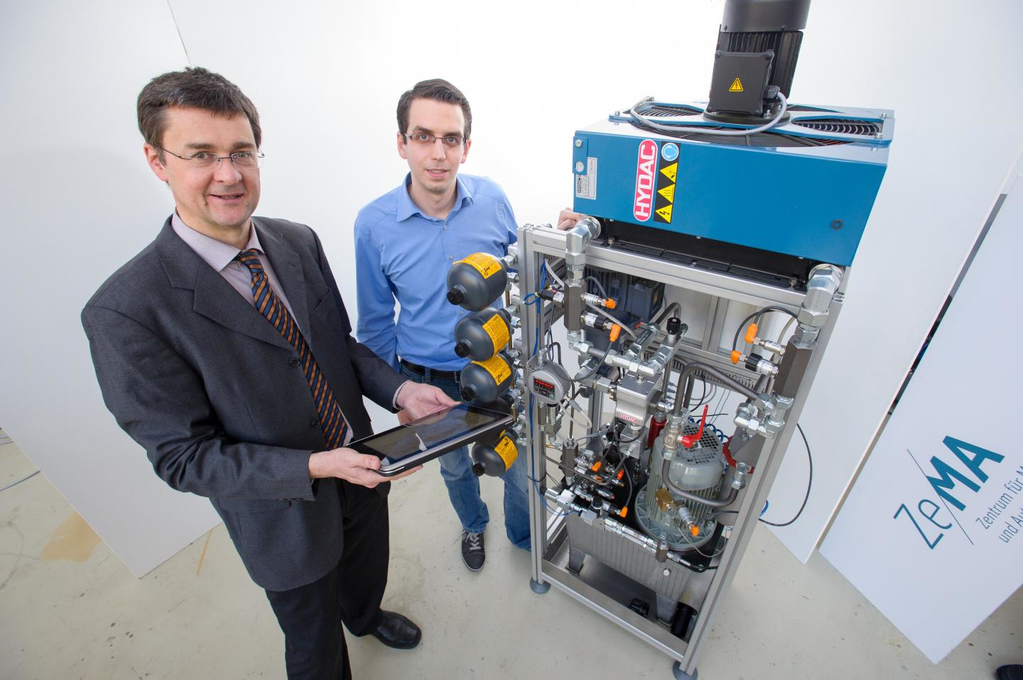 Professor Andreas Schuumltze of Saarland University and graduate engineer Nikolai Helwig who codeveloped the hydraulic test bench presented the smart monitoring system at the 2015 Hannover Messe