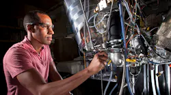 Sandia researchers Isaac Ekoto pictured and Benjamin Wold are part of a team researching automotive engines that replace sparkplugs with autoignition devices The research could help meet automotive engine goals for cleaner emissions and a 545 miles per gallon fuel economy by 2025