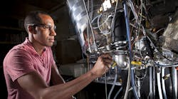 Sandia researchers Isaac Ekoto (pictured) and Benjamin Wold are part of a team researching automotive engines that replace sparkplugs with auto-ignition devices. The research could help meet automotive engine goals for cleaner emissions and a 54.5 miles per gallon fuel economy by 2025.