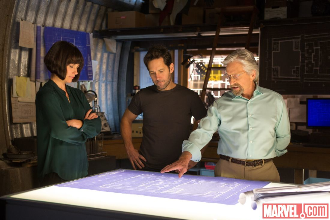 The image above provided by Marvelcom shows Hank Pym Michael Douglas Scott Lang Paul Rudd and Hope Van Dyne Evangeline Lilly analyzing blueprints and tech designs in the upcoming AntMan movie
