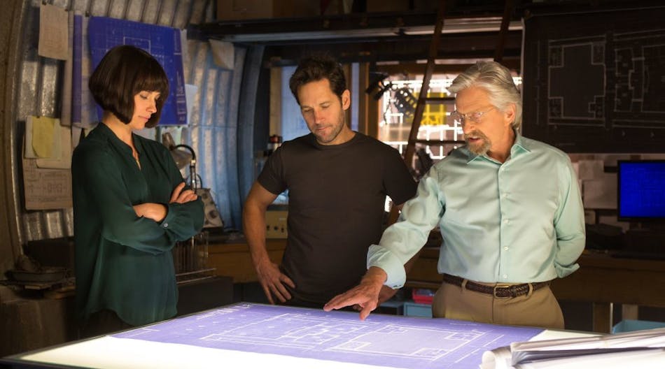 The image above, provided by Marvel.com, shows Hank Pym (Michael Douglas), Scott Lang (Paul Rudd), and Hope Van Dyne (Evangeline Lilly), analyzing blueprints and tech designs in the upcoming Ant-Man movie.