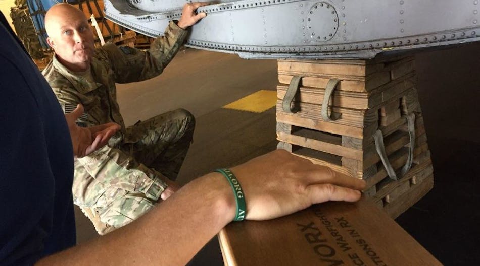 The Junior Force Warfighters Operations in the Air Force Research Laboratory Materials and Manufacturing Directorate discuss replacing the old 85-lb wooden milk stool for C-130 aircraft with Tech. Sgt. Shawn Cooper.