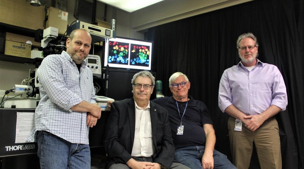 Pictured left to right are NRL researchers Drs. Igor Medintz, Alexander Efros, Alan Huston, and James Delehanty in front of a customized fluorescence microscope equipped for injecting quantum dots and other nanoparticles into living cells.