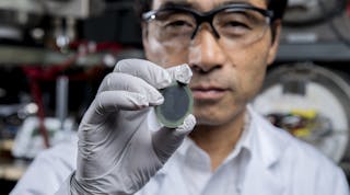 Principal investigator Meilin Liu holds up an example of the new, practical, affordable fuel cell in his lab at the Georgia Institute of Technology.
