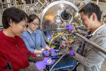 NSLS-II scientist Wen Hu (center) works with MIT researchers Mantao Huang (l) and Aik Jun Tan (r) at the Coherent Soft X-Ray Scattering (CSX) beamline.