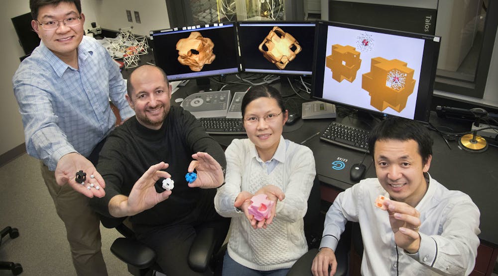 Yugang Zhang, Oleg Gang, Fang Lu, and Mingzhao Liu hold structural models of &ldquo;nanowrappers&rdquo; made of gold and silver and featuring holes in the corners. The scientists synthesized these hollow, porous nanostructures through a chemical reaction and characterized them using electron microscopy and optical spectroscopy capabilities at Brookhaven Lab&apos;s Center for Functional Nanomaterials.