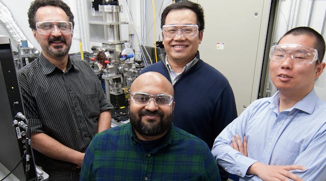 Argonne scientists who worked on a project to avoid defects in 3D-printed parts pose in front of a device that simulates laser powder bed fusion in a commercial 3D printer. Pictured, clockwise from top left, are Kamel Fezzaa, an APS beamline scientist; Tao Sun, an APS beamline scientist; Cang Zhao, an APS postdoc, and Niranjan Parab, an APS postdoc.
