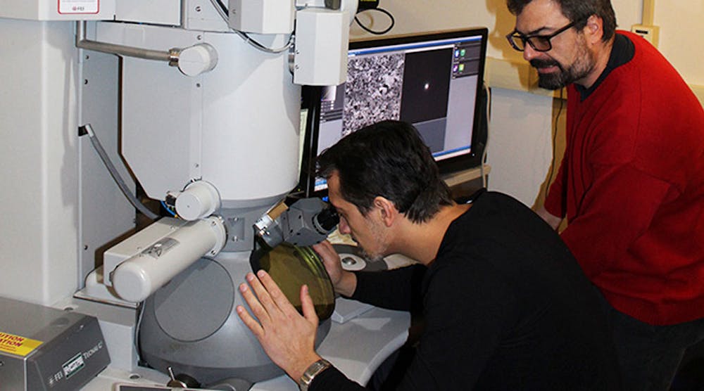 Osman El Atwani (left) and Enrique Martinez Saez examine the new tungsten alloy using a transmission electron microscope.