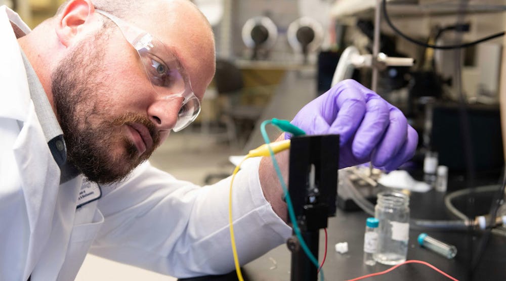 Dylan Christiansen, a graduate research assistant at Georgia Tech studies the electrochromic properties of new materials in a transparent electrochemical cell that allows examination of color changes upon application of an oxidizing voltage.