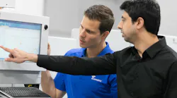 Two men reviewing data