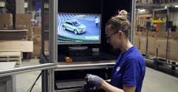 Employee donning charged scanner Employee donning charged scanner