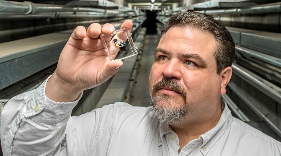 Joshua Whiting, an analytical chemist at Sandia National Laboratories, examines a gas sensor that could be used in sensitive portable devices to detect chemical weapons or airborne toxins.