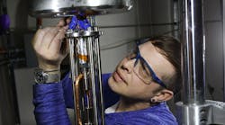Brendan Davis, a designer and operator of high-pressure mechanical testing gear in the Hydrogen Effects on Materials Laboratory at Sandia National Laboratories, prepares to test hydrogen gas.