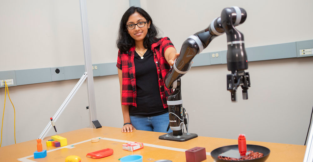 Woman holding a robotic arm