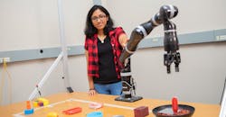 Woman holding a robotic arm Woman holding a robotic arm