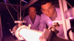 Georgia Tech Professor Lukas Graber and Postdoctoral Fellow Chanyeop Park study the plasma potential surrounding materials being evaluated for use in improved DC circuit breakers. The low-energy argon plasma creates the purple color.
