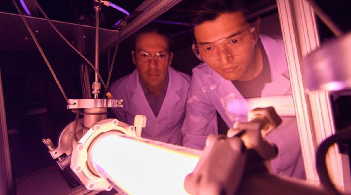 Georgia Tech Professor Lukas Graber and Postdoctoral Fellow Chanyeop Park study the plasma potential surrounding materials being evaluated for use in improved DC circuit breakers. The low-energy argon plasma creates the purple color.