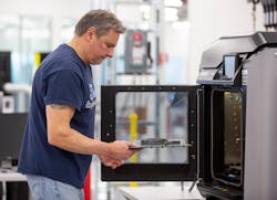 Dave Jacek, 3D printing technician, unloads 3D-printed medical face shield parts at Ford’s Advanced Manufacturing Center. Dave Jacek, 3D printing technician, unloads 3D-printed medical face shield parts at Ford’s Advanced Manufacturing Center.