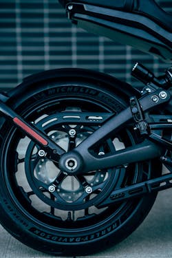 The rear wheel is powered by a belt drive. The rear fender hugs and moves up and down with the wheel so that it almost disappears when the bike is moving. This permits the tail section’s high, wasp-like contour below the seat. The rear wheel is powered by a belt drive. The rear fender hugs and moves up and down with the wheel so that it almost disappears when the bike is moving. This permits the tail section’s high, wasp-like contour below the seat.