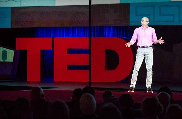Historian Yuval Noah Harari appearing as a hologram on the TED stage.