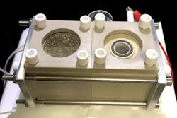 A device to capture carbon dioxide from the air and convert it to useful organic products. On left is the chamber containing the nanowire/bacteria hybrid that reduces CO2 to form acetate. On the right is the chamber where oxygen is produced.