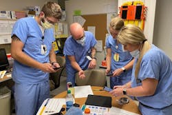 Healthcare providers in the WVU Medicine J.W. Ruby Memorial Hospital Emergency Department receive their digital PPE from RNI team members.