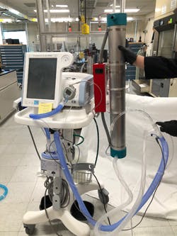 Sandia researchers developed kits that attach to respiratory machines and use UV light to disable COVID-19 and other pathogens before a patient&rsquo;s exhaled breath is circulated back into the hospital room (metal tube on the right side of the ventilator).