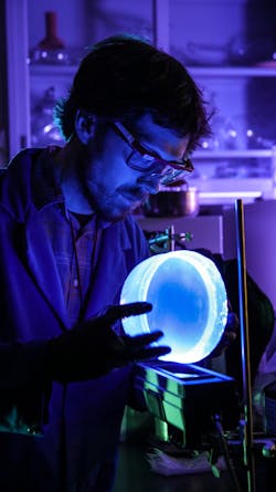 Nick Myllenbeck, a materials scientist at Sandia National Laboratories, examines the plastic used to detect radioactive material. Nick Myllenbeck, a materials scientist at Sandia National Laboratories, examines the plastic used to detect radioactive material.