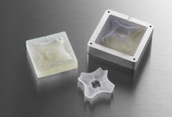 3D-printed injection molds in an aluminum frame with the finished injection molded part. 3D-printed injection molds in an aluminum frame with the finished injection molded part.