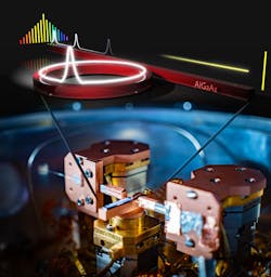 This experimental setup generates a set of stable frequencies in a cryogenically cooled laser frequency comb. The ring-shaped microresonator, small enough to fit on a microchip, operates at low laser power and is made from the semiconductor aluminum gallium arsenide. This experimental setup generates a set of stable frequencies in a cryogenically cooled laser frequency comb. The ring-shaped microresonator, small enough to fit on a microchip, operates at low laser power and is made from the semiconductor aluminum gallium arsenide.
