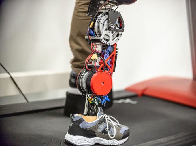 A student tests the robotic leg at the University of Texas at Dallas. Strong motors powering the knee and ankle propel the user&rsquo;s body while still letting the knee swing freely.