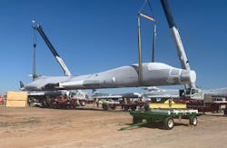 The B-1B tail is lifted and placed on flatbed trailers for the 1,000-mile journey to Wichita, Kan. The National Institute for Aviation Research at Wichita State University will create a digital twin that can be used for research.