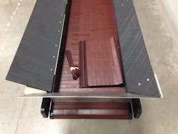 The brownish high-temperature nylon conveyor belt is modular and can quickly be repaired to minimize downtime.
