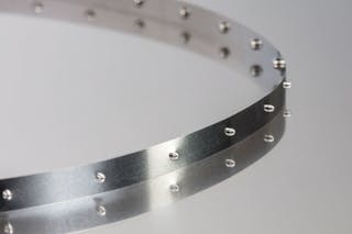 Metal drive tapes are made from the same stainless steel as metal belts but are open-ended and anchored at each end.