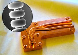 SLAC scientists have invented a copper accelerator structure that could make future X-ray lasers and accelerators for radiation therapy more compact. It feeds terahertz radiation into a tiny cavity to boost particles to tremendous energies. This image shows one half of the structure with the cavity in the circled area. Inset: Scanning electron microscope image of a section of the cavity, which is 3.5 mm long and 280 microns wide at its narrowest point. SLAC scientists have invented a copper accelerator structure that could make future X-ray lasers and accelerators for radiation therapy more compact. It feeds terahertz radiation into a tiny cavity to boost particles to tremendous energies. This image shows one half of the structure with the cavity in the circled area. Inset: Scanning electron microscope image of a section of the cavity, which is 3.5 mm long and 280 microns wide at its narrowest point.