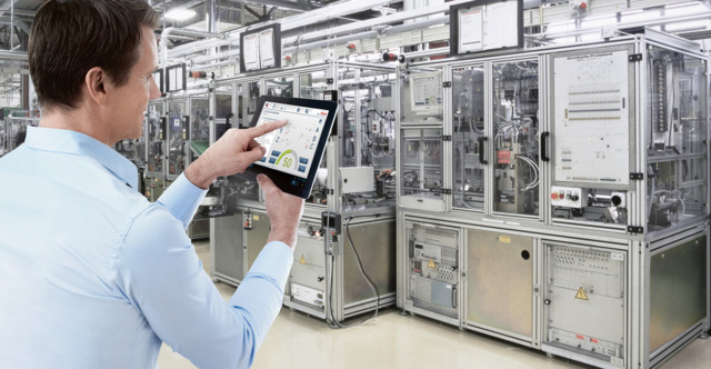 Man using tablet on a factory floor