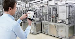 Man using tablet on a factory floor Man using tablet on a factory floor