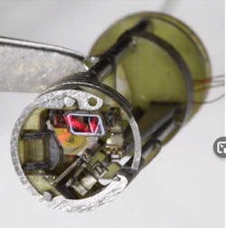 3. The X-Y laser-steering mirrors are driven by MEMS-based flexures; one mirror is clearly visible at the top due to the red laser glow. 3. The X-Y laser-steering mirrors are driven by MEMS-based flexures; one mirror is clearly visible at the top due to the red laser glow.