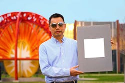 Xiulin Ruan, a Purdue University professor of mechanical engineering, holds a sample of the whitest paint on record.
