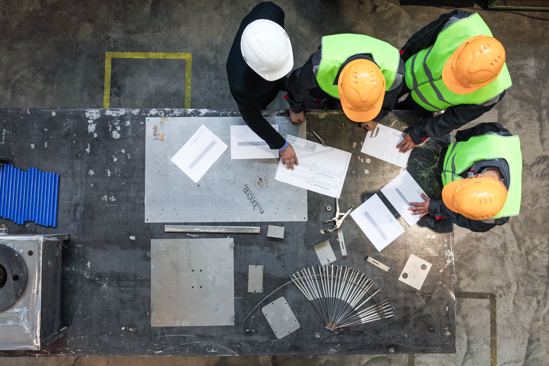 Workers looking over documents at a worksite
