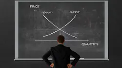 Man contemplating supply and demand on a blackboard
