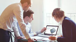 Workers looking at laptop