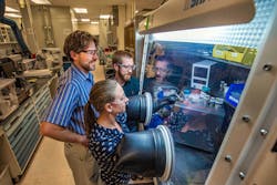 Sandia National Laboratories researchers work in an argon glove box on a lab-scale sodium iodide battery prototype. This new kind of molten sodium battery could prove to be a lower-temperature, lower-cost battery for grid-scale energy storage.