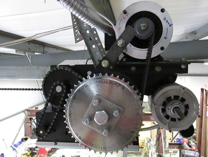 For improved control, the OEM motor (shown above at bottom right) was replaced by an AutomationDirect IronHorse motor (top right), and a bicycle sprocket was installed in conjunction with an AutomationDirect AHS Series extended range inductive proximity sensor to act as a pulse-counting position indicator.