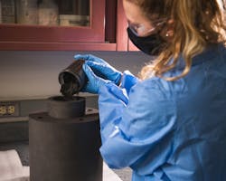Laboratory scientist Brianna Musico demonstrates the powder loading for the P-HIP process. Laboratory scientist Brianna Musico demonstrates the powder loading for the P-HIP process.